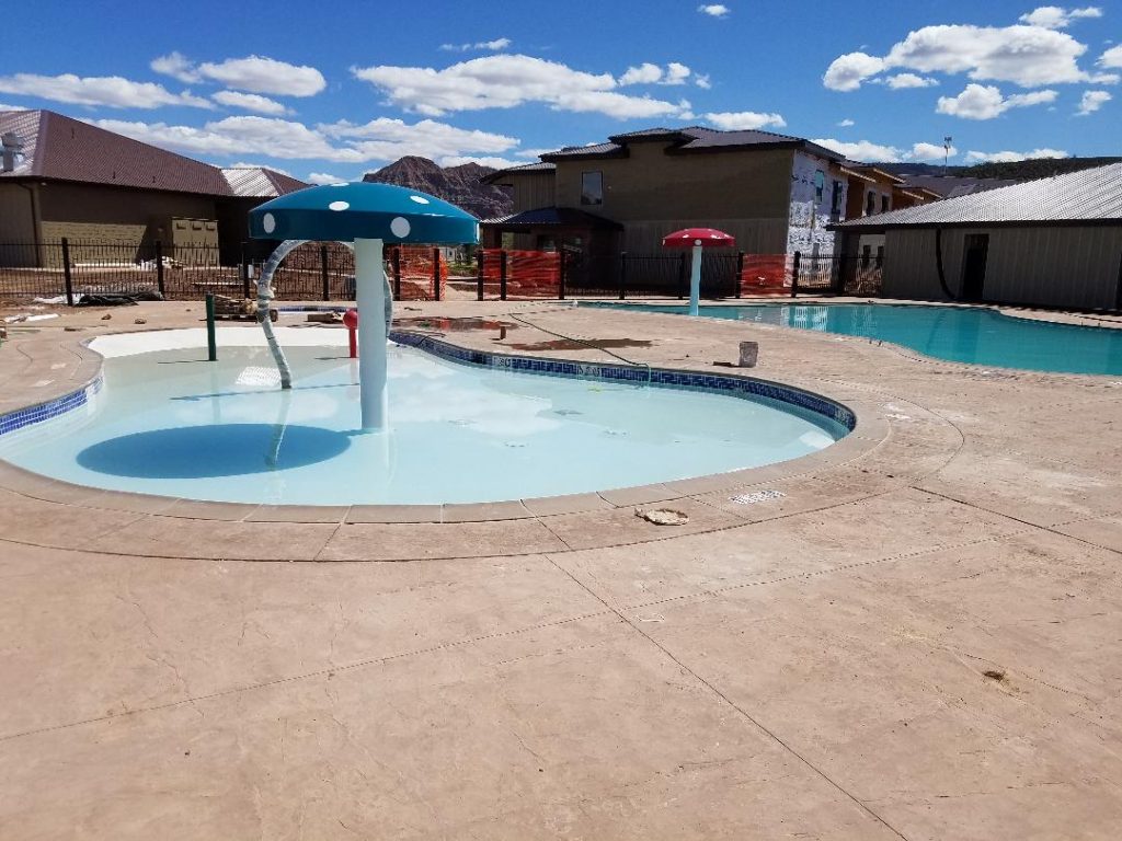 Kiddie pool splash pad water sprinkler feature in commercial swimming pool near Hurricane Ut.