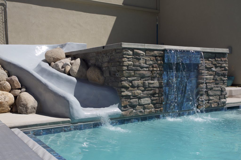 The waterslide off the spa allows a family to have fun and safe swimming experience.
