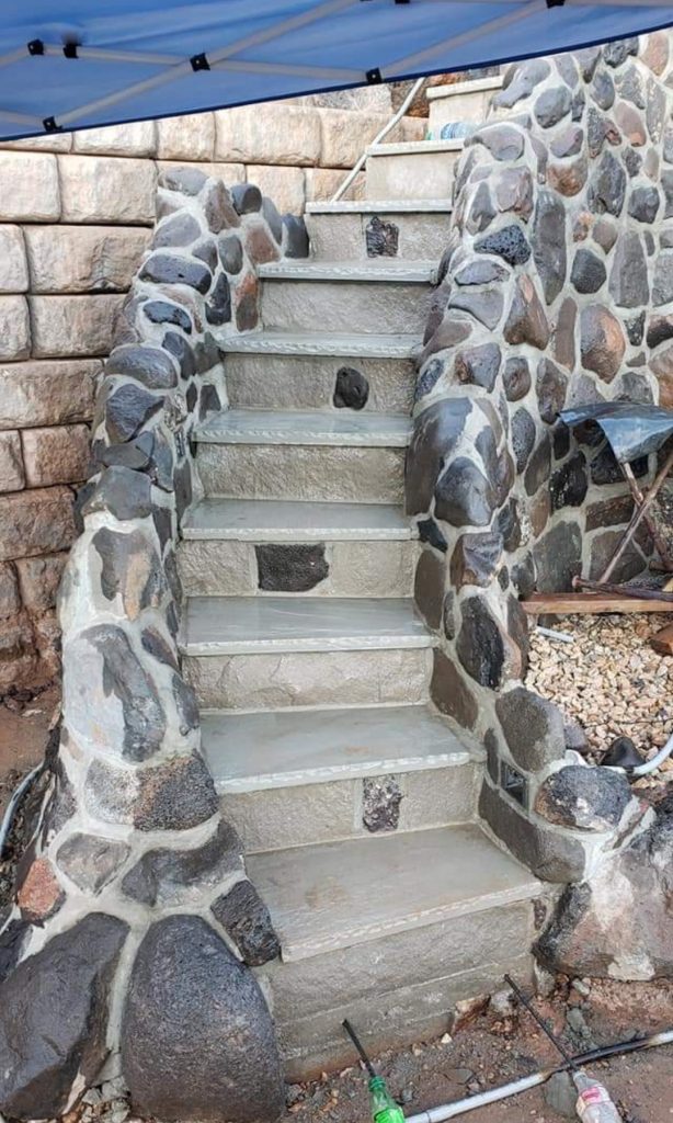 These natural stone stairs are inlayed with different color stone to give a very custom look that is both functional and beautfiul.