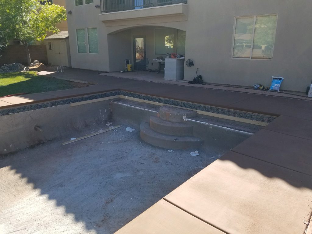 Gunite is poured, waiting on plaster and tile work for this swimming pool.