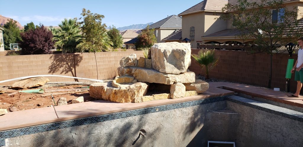 A simpler swimming pool rock water feature for a backyard in Hurricane.