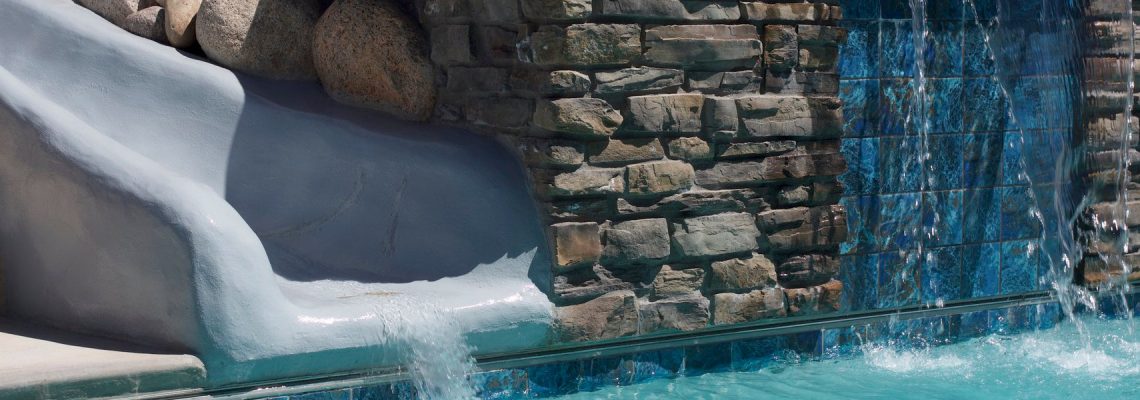 This custom swimming pool was created with a natural stone waterfall and waterslide in Hurricane Utah.