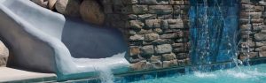 This custom swimming pool was created with a natural stone waterfall and waterslide in Hurricane Utah.