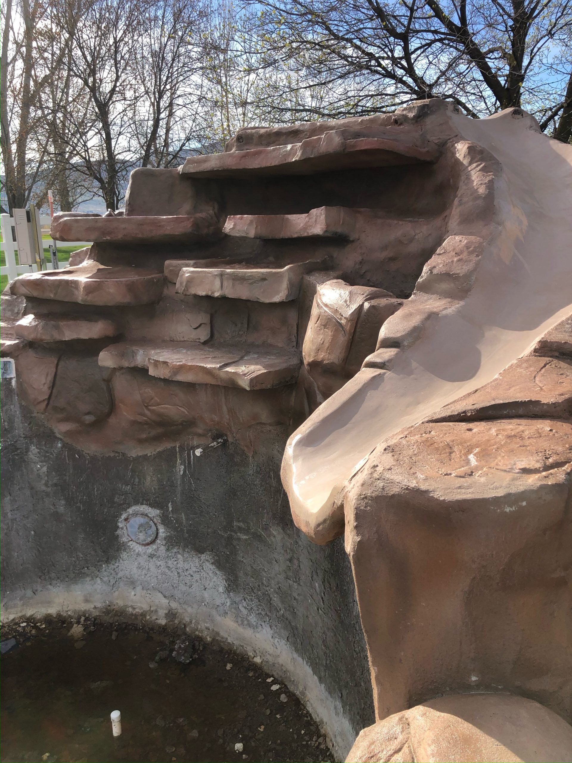 Custom swimming pool water feature with slide in Tremonton Utah