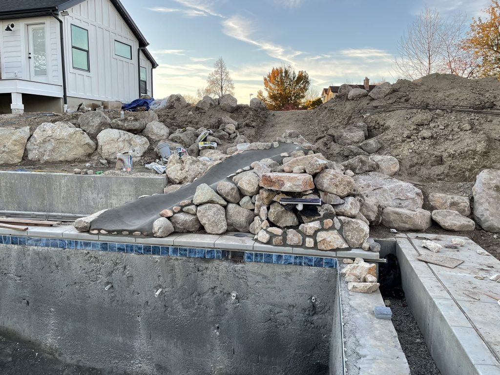 Custom water feature and slide for swimming pool built in Brigham City Utah by GTD Construction, Northern Utah's premier pool builder.